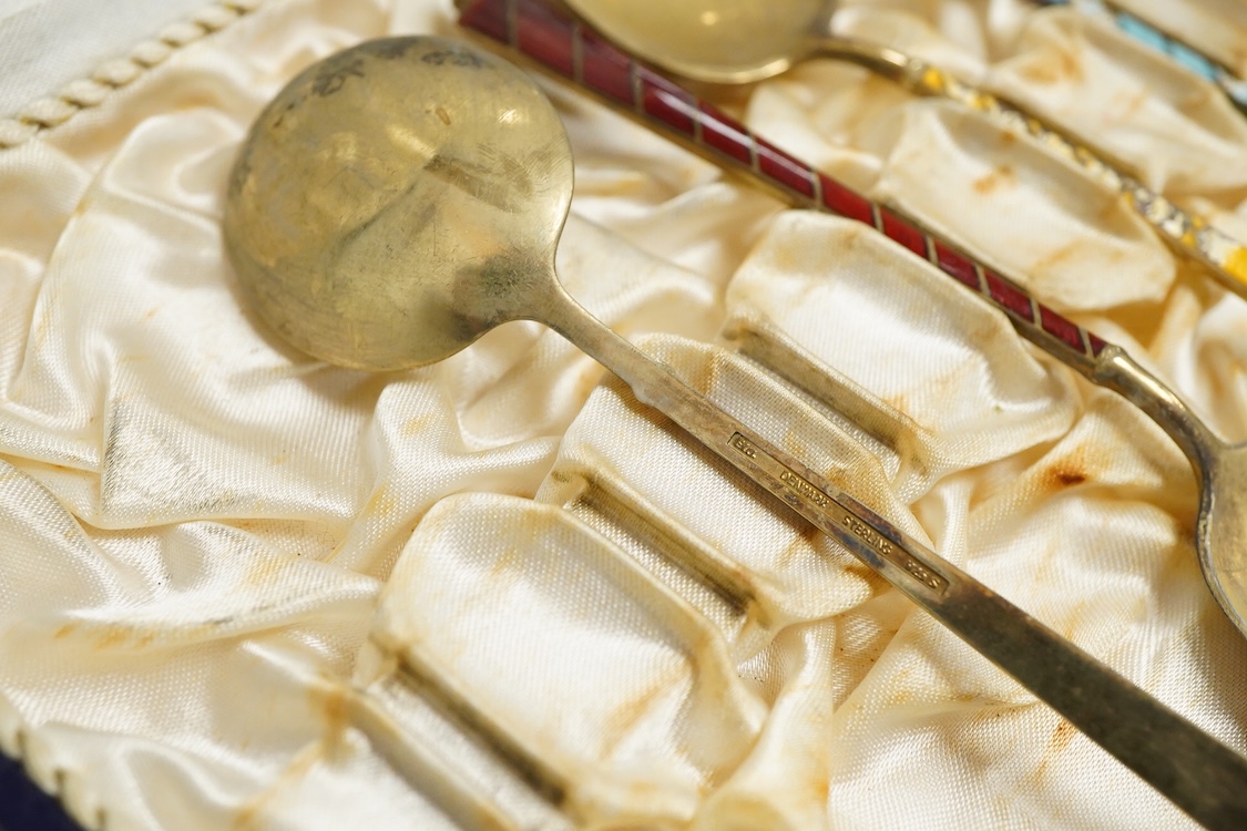 An Edwardian silver elliptical shaped inkstand, with two mounted glass wells and central pen wipe, James Dixon & Sons, Sheffield, 1906, together with ten Danish sterling and polychrome enamel spoons(a.f) and a cased set